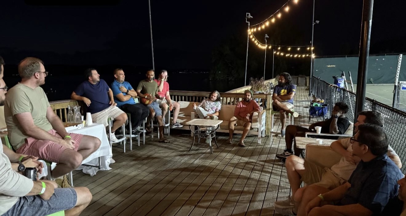 Dads listening and sharing at a waterfront gathering